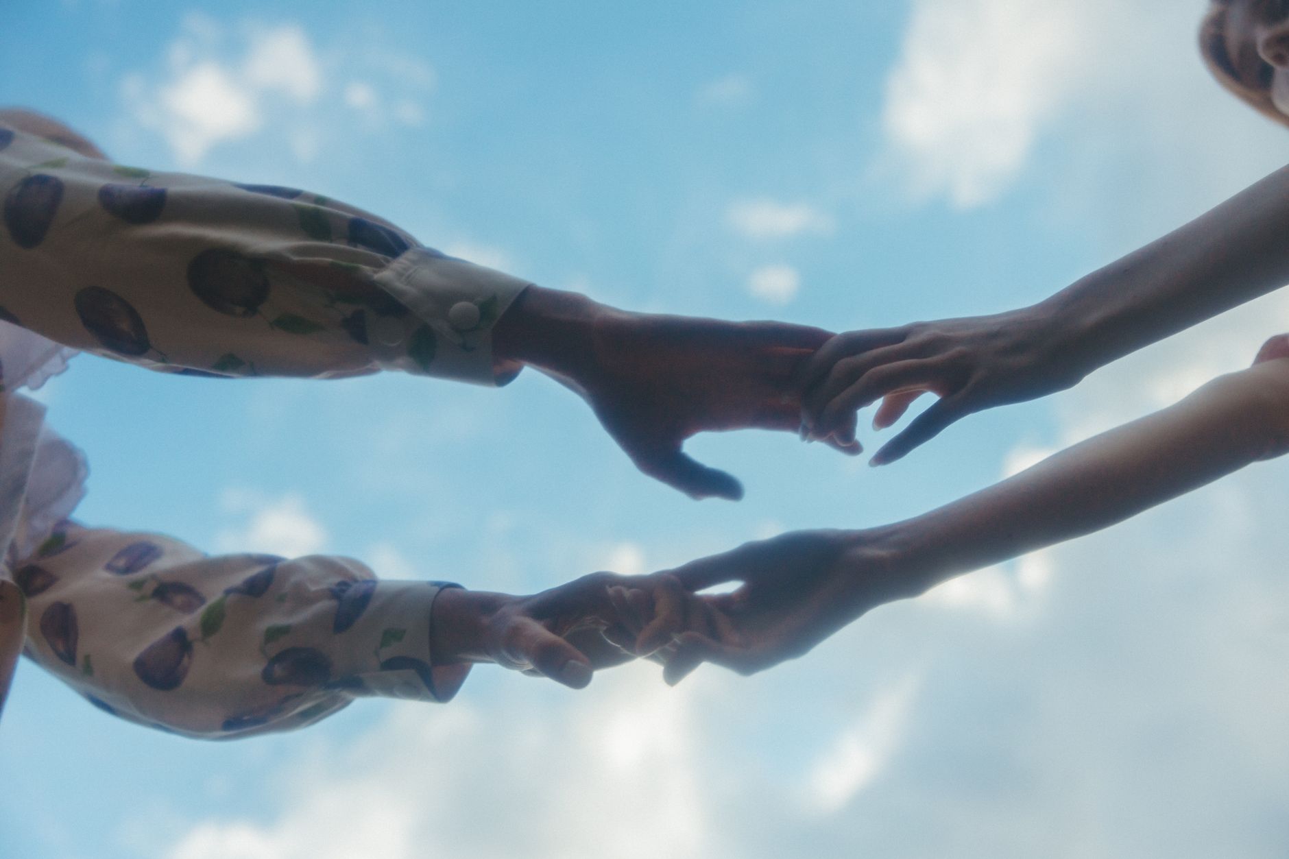 Two hands reaching toward each other in comfort